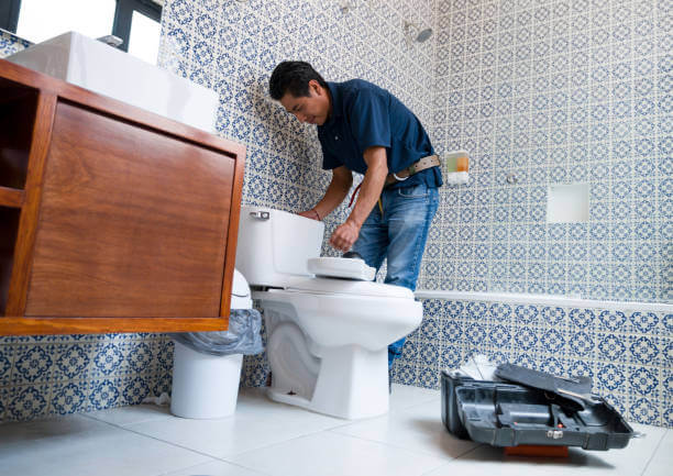 plumber repairing toilet