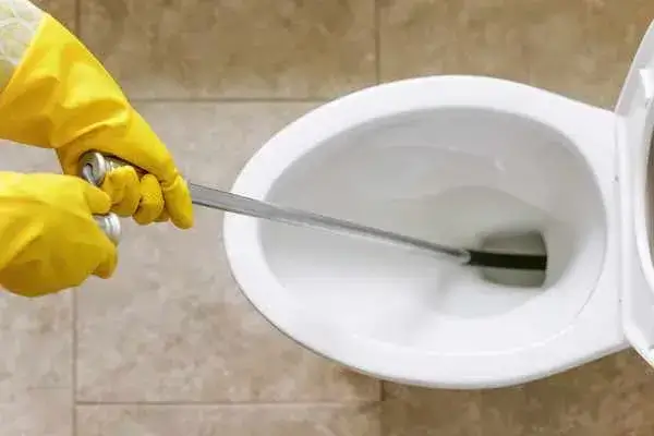 Using Auger to Unclog a Toilet