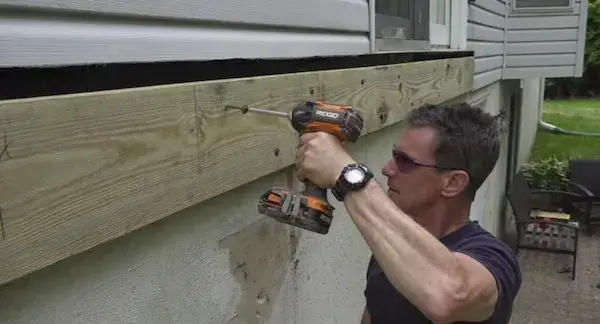 attaching deck ledger board to house