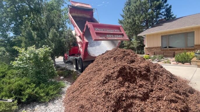 Image of truck delivering wood mulch - besthomegear.com